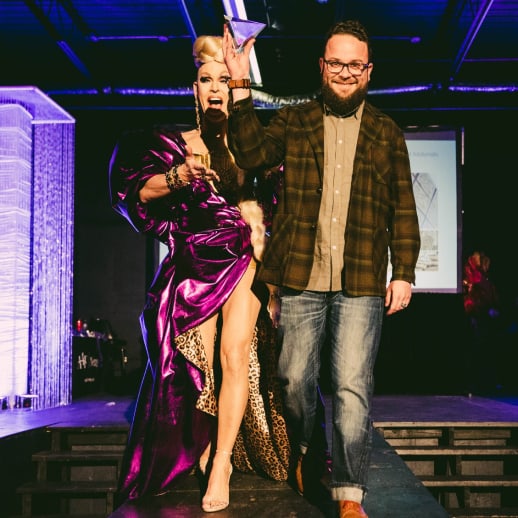 Addy award winner escorted down the runway by drag queen emcee